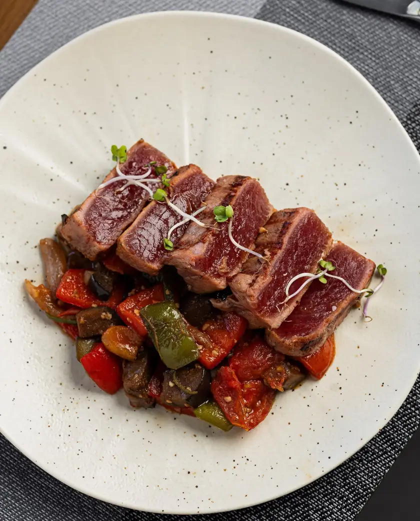 Seared tuna on sautéed peppers and tomato